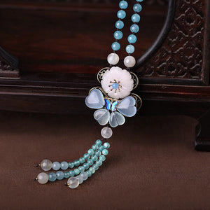 blue long necklace, with Oriental style butterfly decorations, blue crystals, and white jade