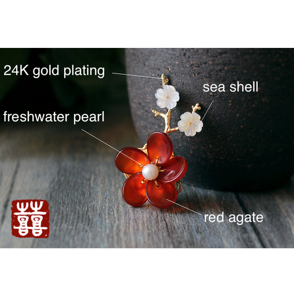This flower brooch is made of red agate, seashell, freshwater pearls and 24K gold plated metal parts